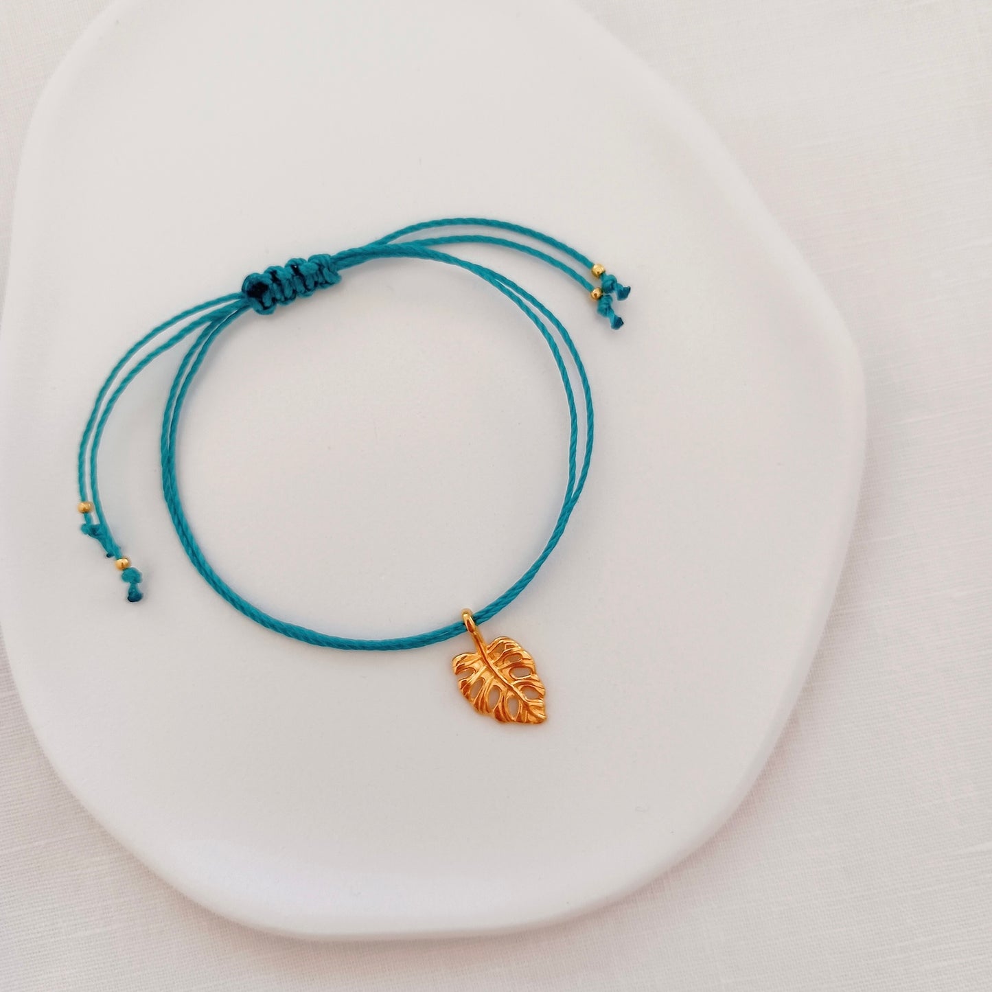 Cord bracelet with monstera charm