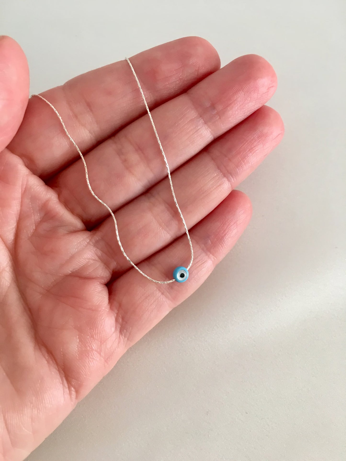 Tiny evil eye necklace