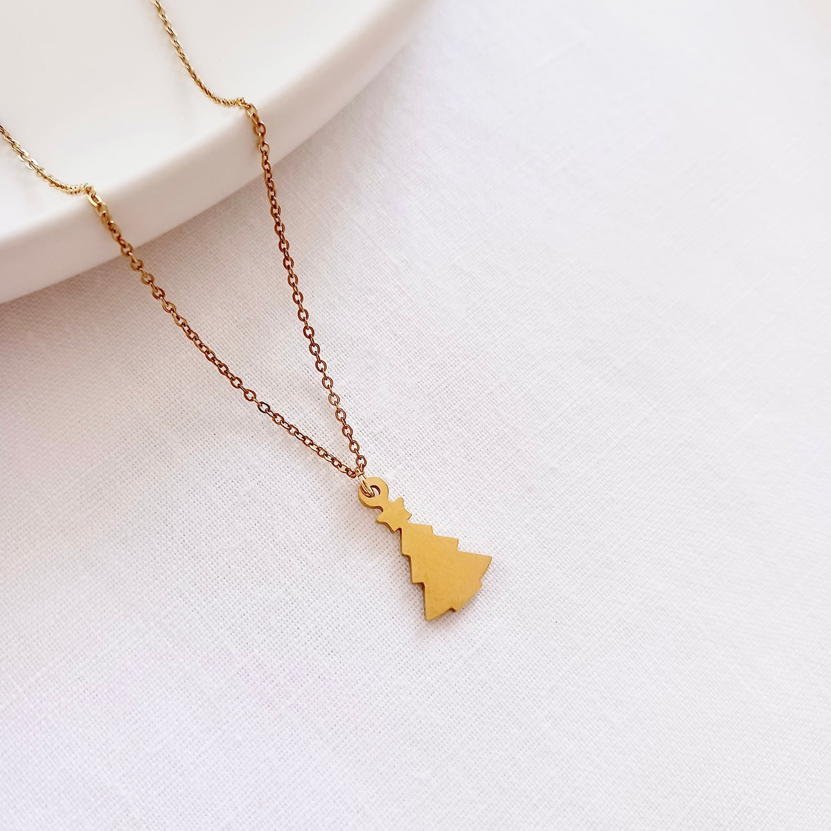 Stainless steel christmas tree chain necklace on holiday message card
