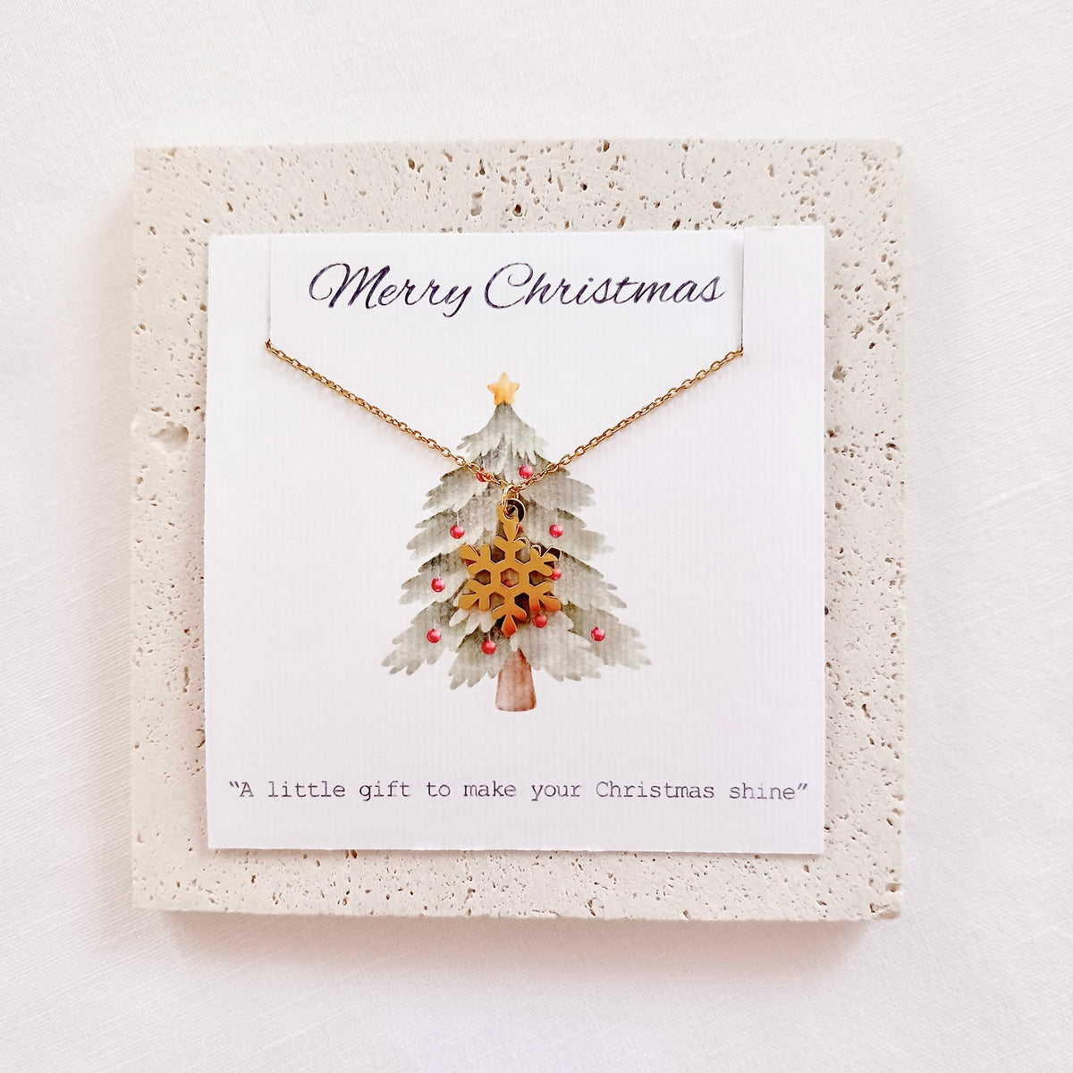 Collier chaîne avec pendentif flocon de neige de Noël en acier inoxydable sur carte de vœux